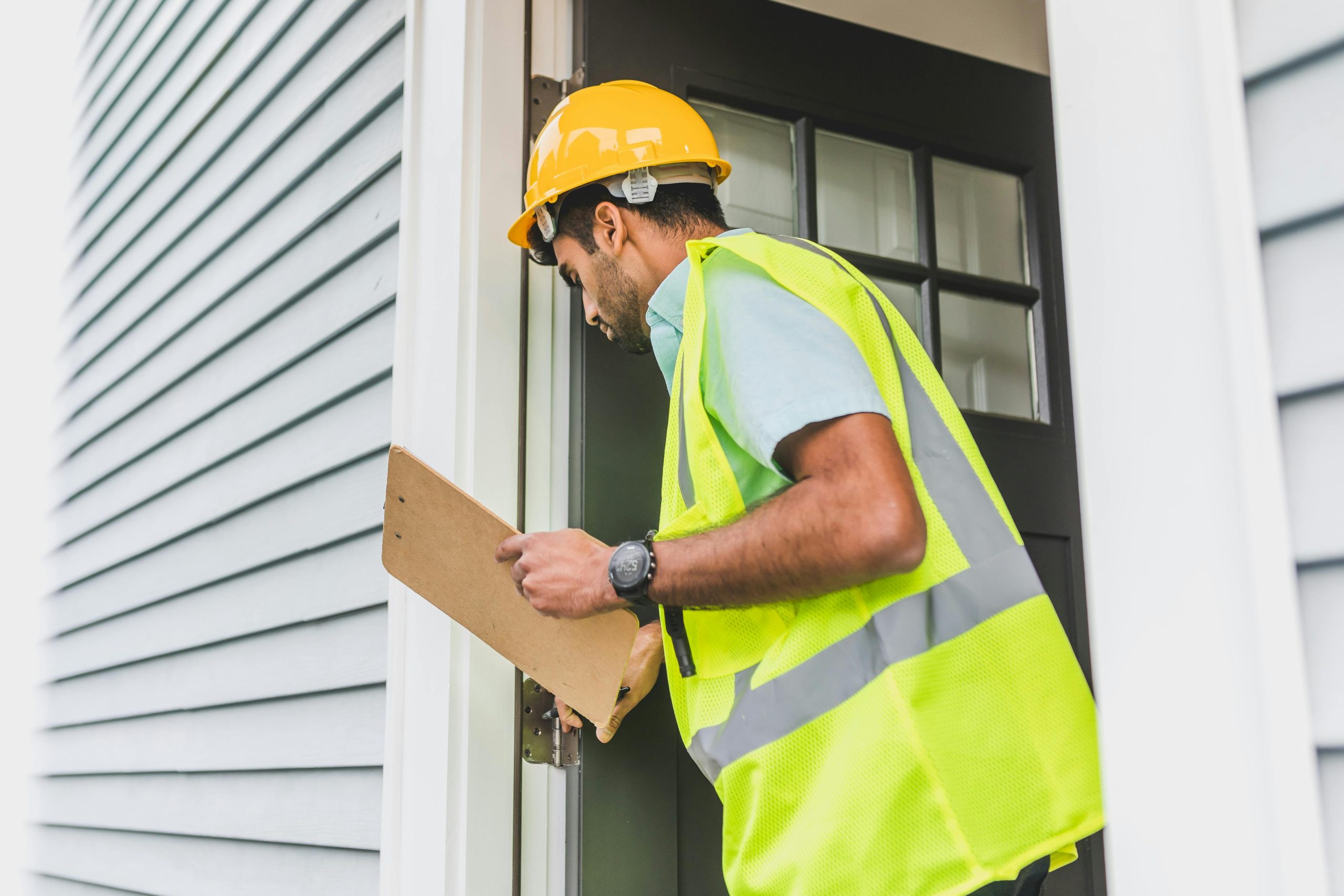 A HVAC repairman entering a home in Merrillville, IN